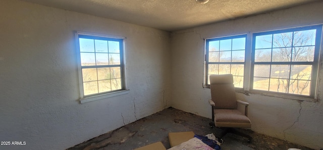 unfurnished room featuring a textured ceiling