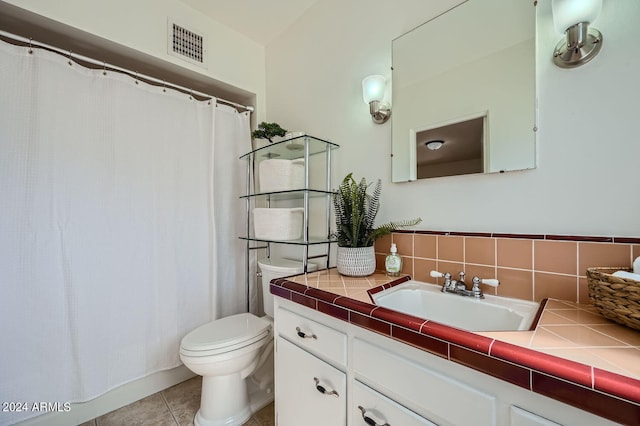 bathroom with backsplash, vanity, tile patterned flooring, and toilet