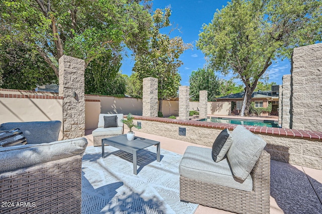 view of patio / terrace featuring outdoor lounge area and a fenced in pool