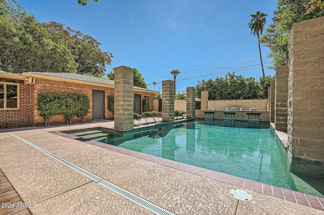 view of swimming pool with a patio