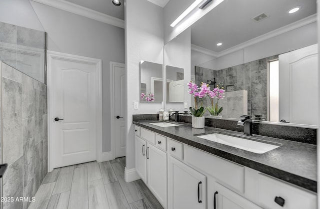 bathroom featuring ornamental molding, walk in shower, double vanity, and recessed lighting