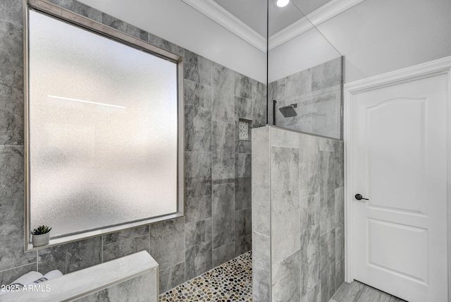 full bathroom with walk in shower, tile walls, and ornamental molding