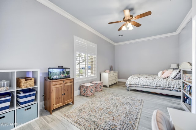 bedroom with ornamental molding, light wood-type flooring, baseboards, and a ceiling fan