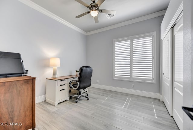 office space featuring ceiling fan, ornamental molding, baseboards, light wood-style floors, and healthy amount of natural light