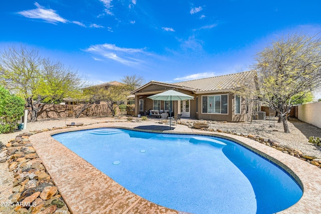 view of pool with a patio, a fenced backyard, and central air condition unit