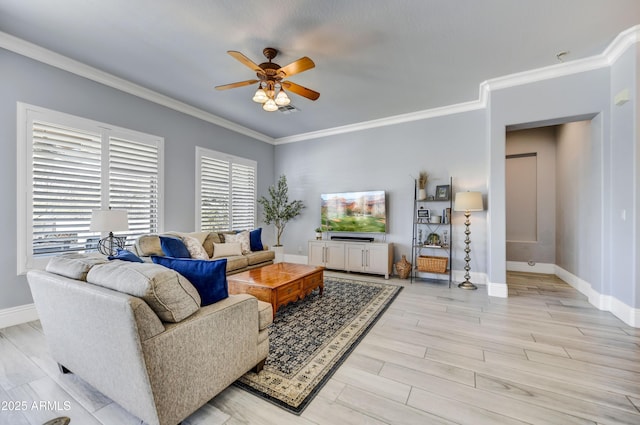 living room featuring a ceiling fan, ornamental molding, light wood-style flooring, and baseboards