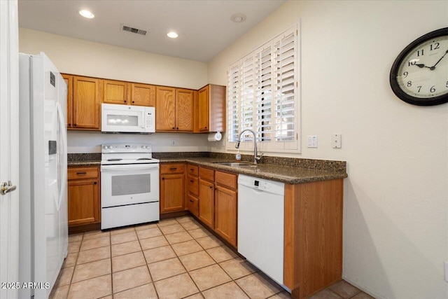 kitchen with sink, white appliances, and light tile patterned floors