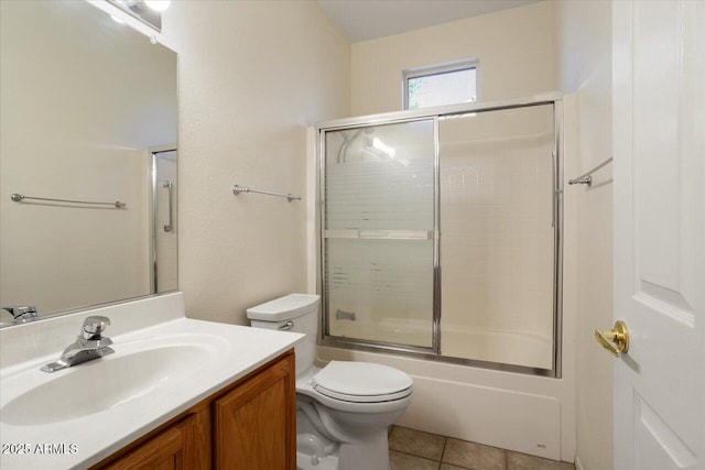 full bathroom with enclosed tub / shower combo, vanity, tile patterned floors, and toilet