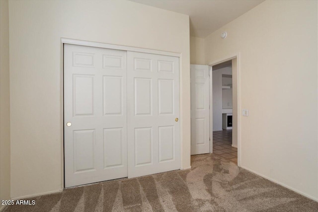 unfurnished bedroom with carpet floors and a closet