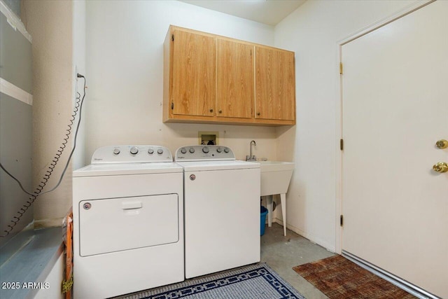 laundry room featuring independent washer and dryer and cabinets