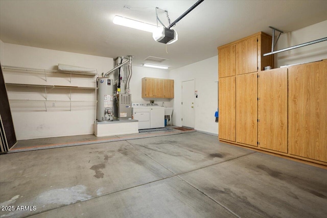 garage with separate washer and dryer, sink, a garage door opener, and water heater