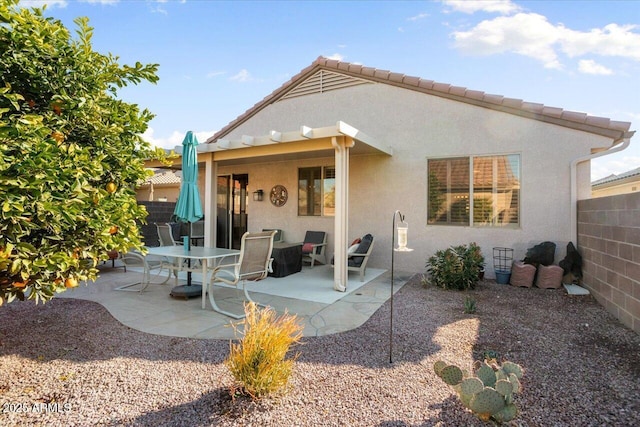 back of property with a patio