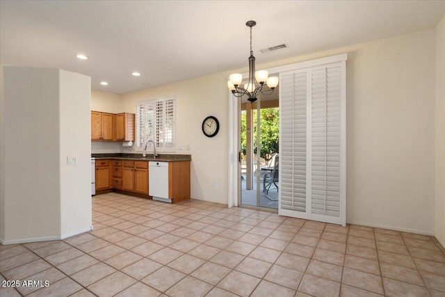 kitchen featuring decorative light fixtures, dishwasher, sink, light tile patterned floors, and an inviting chandelier