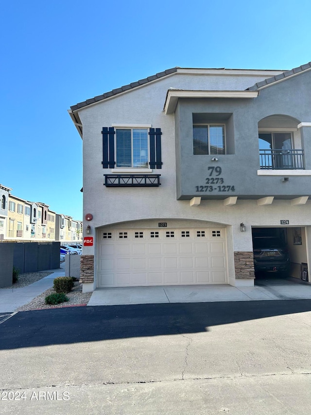 view of front of home with a balcony and a garage