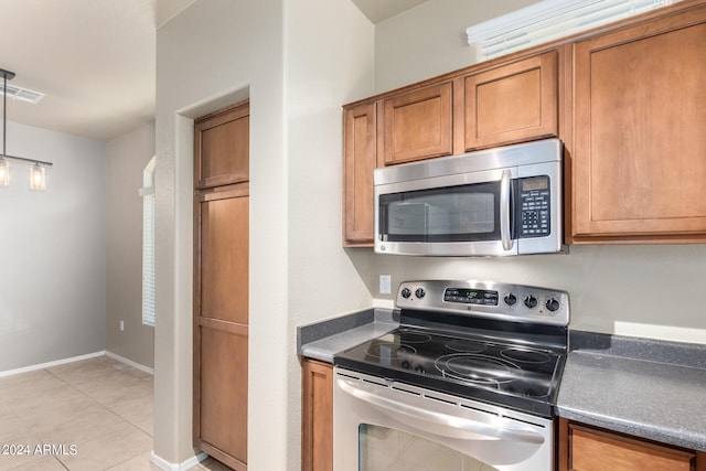 kitchen featuring appliances with stainless steel finishes and light tile patterned floors