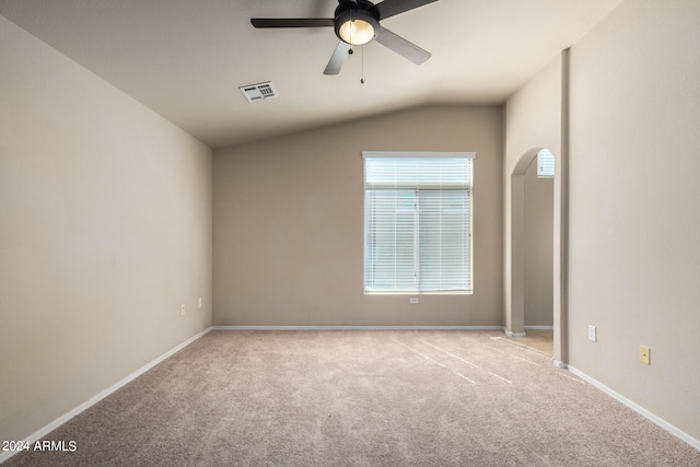 carpeted empty room with lofted ceiling and ceiling fan