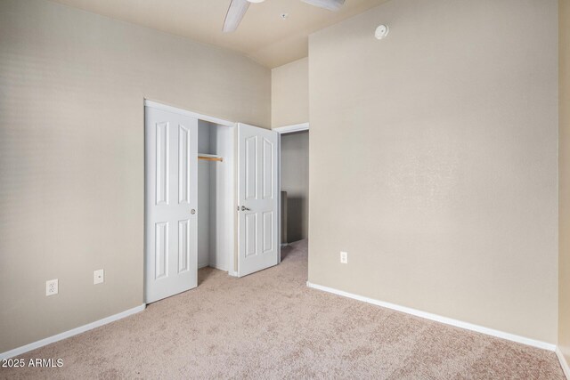 spare room with vaulted ceiling, ceiling fan, and light carpet