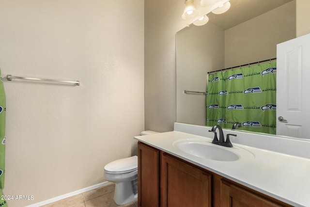 bathroom featuring tile patterned flooring, vanity, and toilet