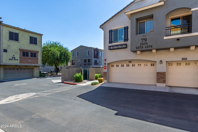 view of front of property featuring a balcony and a garage