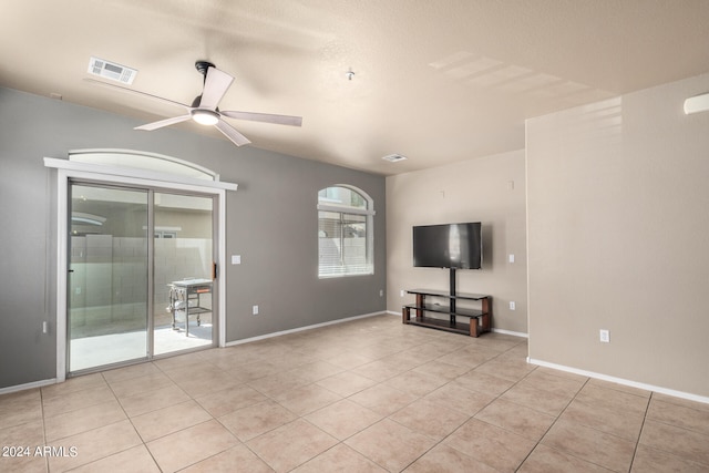 unfurnished living room featuring light tile patterned floors and ceiling fan