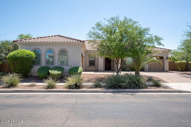 mediterranean / spanish house featuring a garage