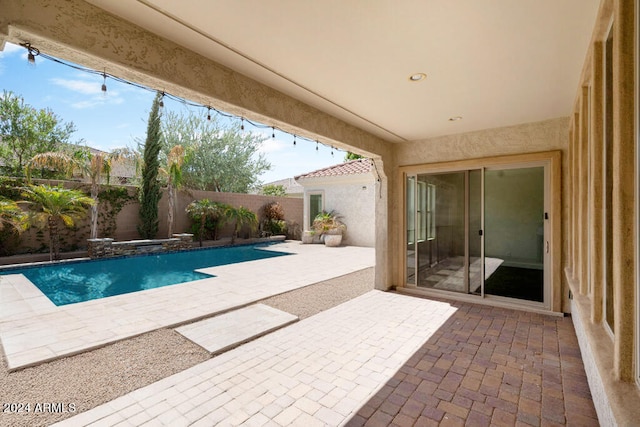 view of swimming pool featuring a patio area