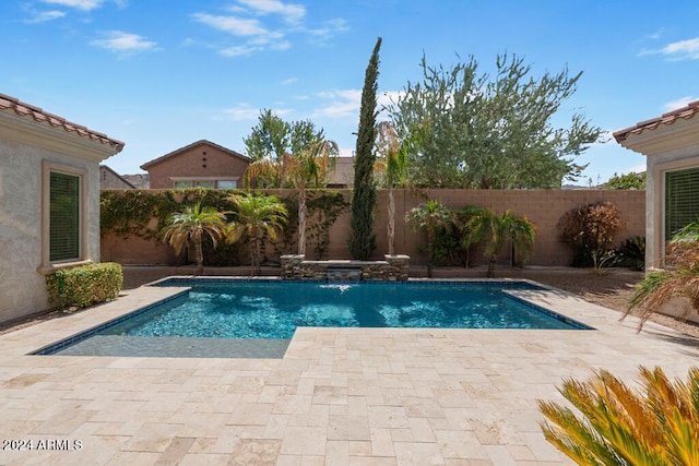 view of pool featuring pool water feature and a patio area