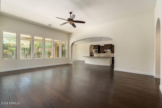 unfurnished living room featuring dark hardwood / wood-style floors and ceiling fan