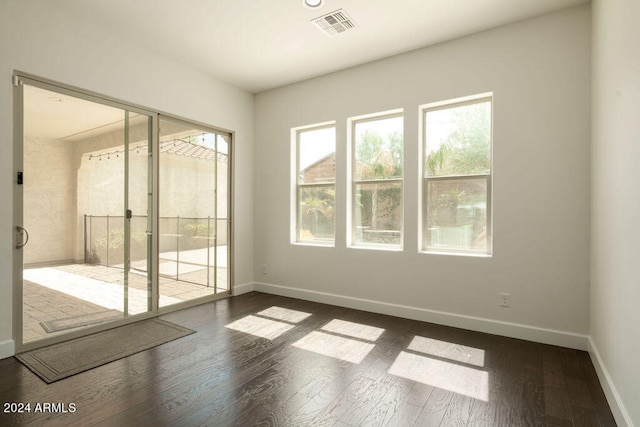 spare room with dark hardwood / wood-style flooring