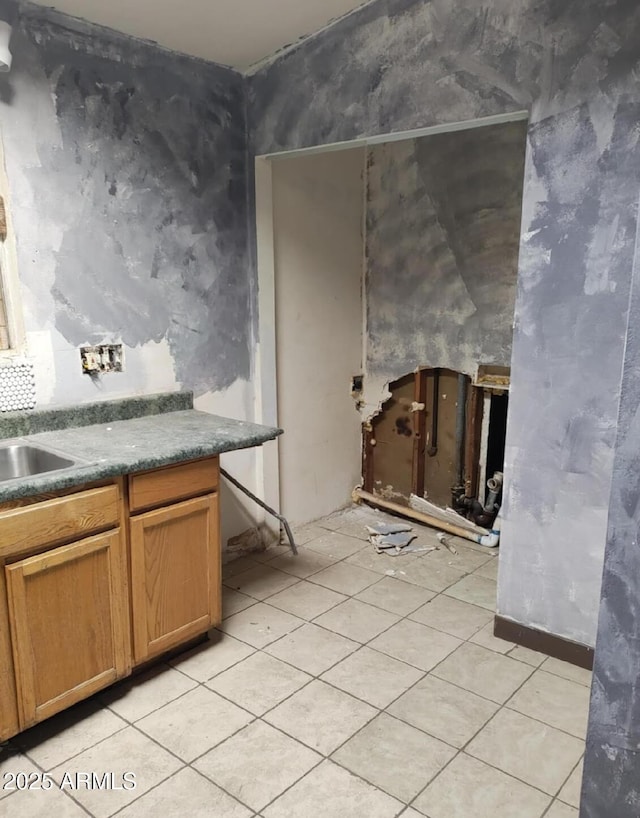 kitchen featuring light tile patterned floors and sink