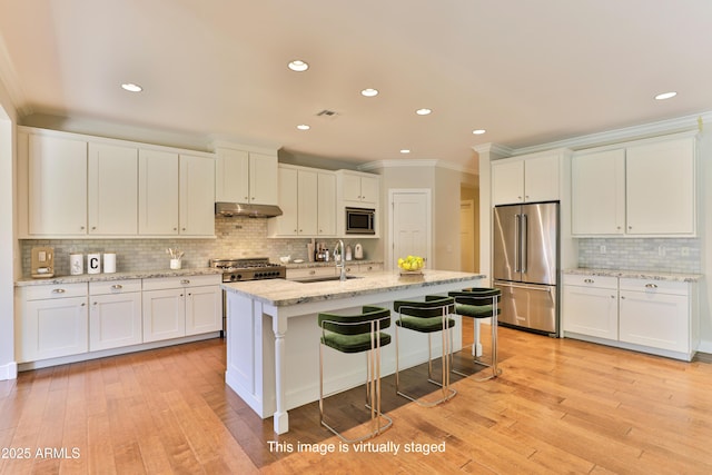 1505 W Orangewood Ave W, Phoenix, AZ 85021 - kitchen featuring appliances with stainless steel finishes, under cabinet range hood, backsplash, ornamental molding, and white cabinetry