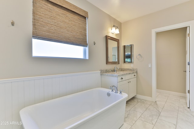 1505 W Orangewood Ave W, Phoenix, AZ 85021 - bathroom with a soaking tub, marble finish flooring, vanity, and a wainscoted wall