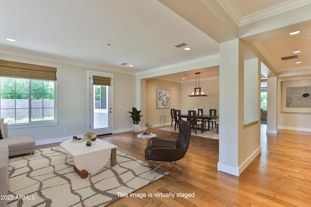 1505 W Orangewood Ave W, Phoenix, AZ 85021 - living area with wood finished floors, ornamental molding, a chandelier, and recessed lighting