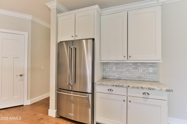 1505 W Orangewood Ave W, Phoenix, AZ 85021 - kitchen with high end fridge, light wood-style floors, tasteful backsplash, ornamental molding, and white cabinetry
