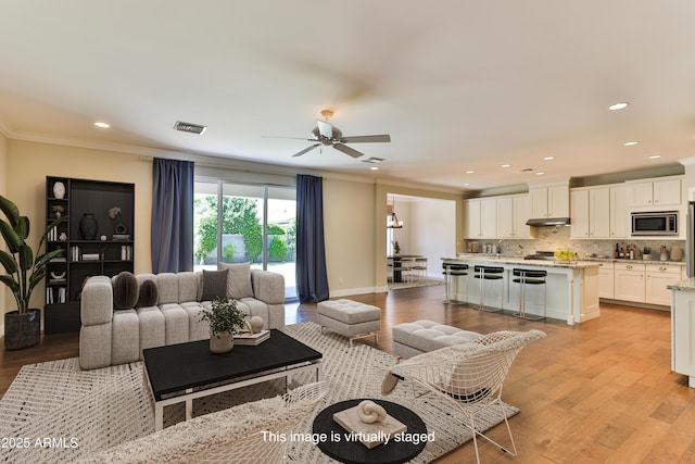 1505 W Orangewood Ave W, Phoenix, AZ 85021 - living area featuring crown molding, a ceiling fan, light wood-style floors, and recessed lighting