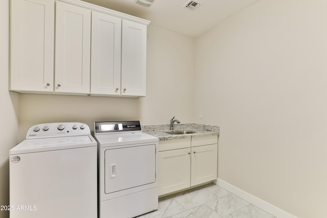 1505 W Orangewood Ave W, Phoenix, AZ 85021 - washroom featuring washing machine and clothes dryer, light marble finish flooring, and cabinet space