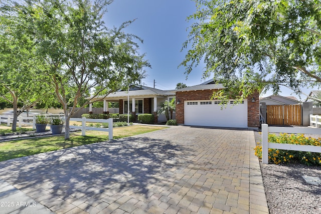 1505 W Orangewood Ave W, Phoenix, AZ 85021 - ranch-style house featuring a garage, brick siding, and decorative driveway
