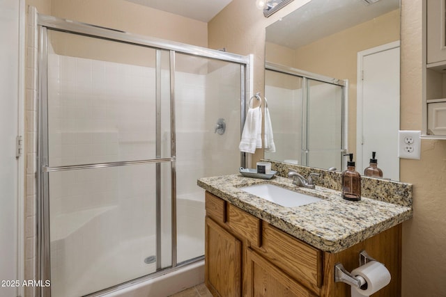 6610 E University Dr Unit 127, Mesa, AZ 85205 - full bath featuring a textured wall, vanity, and a shower stall