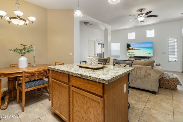 6610 E University Dr Unit 127, Mesa, AZ 85205 - kitchen featuring light tile patterned floors, a kitchen island, a ceiling fan, open floor plan, and hanging light fixtures