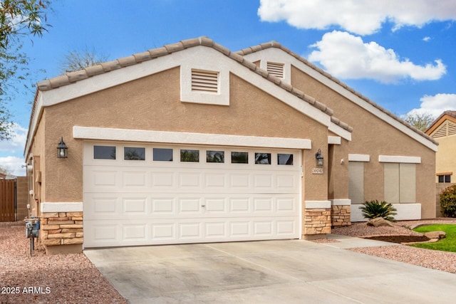 view of front facade with concrete driveway, stone siding, and stucco siding