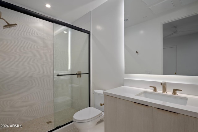 bathroom with a shower with door, toilet, and large vanity