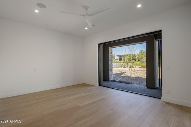 spare room featuring ceiling fan and light hardwood / wood-style flooring