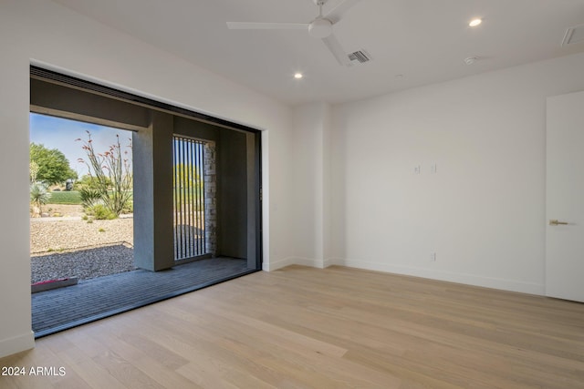 unfurnished room with ceiling fan and light hardwood / wood-style flooring