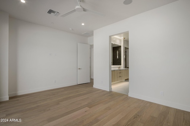 unfurnished room with ceiling fan and light hardwood / wood-style flooring