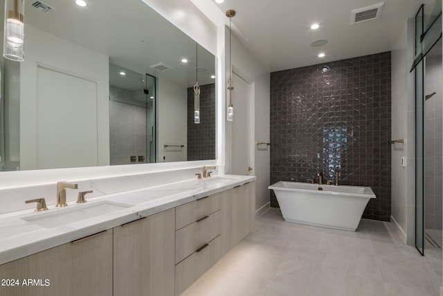 bathroom with tile walls, double vanity, tile flooring, and separate shower and tub