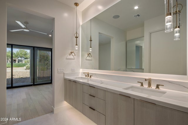 bathroom with dual vanity, ceiling fan, and tile floors