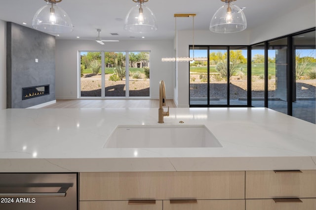 kitchen featuring sink, hanging light fixtures, and plenty of natural light