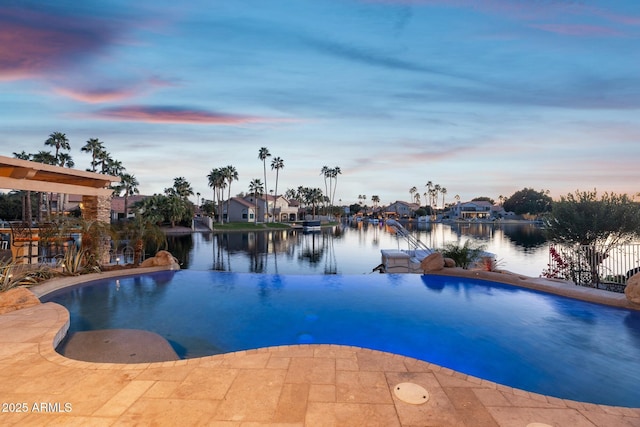 pool at dusk with a water view