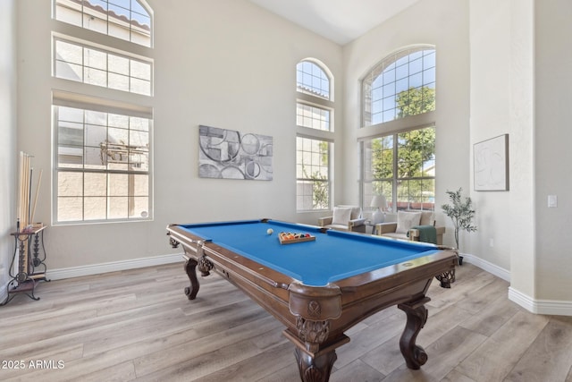 playroom featuring billiards, wood finished floors, a towering ceiling, and baseboards