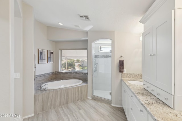 full bath with a stall shower, visible vents, a garden tub, and vanity